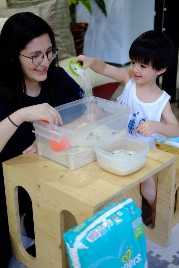 Pampers Power Mom Janice Lagman-Lizardo with baby Jace enjoying his rice sensory bin to boost play and learning